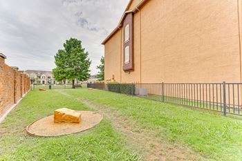 Fenced backyard with decorative rock feature